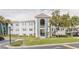 Condominium exterior featuring a blue and white color scheme and well-maintained landscaping at 1109 Clubside Dr # 1109, Longwood, FL 32779