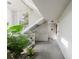 Hallway with tile floor, staircase, and tropical plants, creating a bright and airy atmosphere at 1109 Clubside Dr # 1109, Longwood, FL 32779