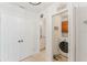 Open hallway view to laundry and bath; laundry room with modern front load appliances at 1109 Clubside Dr # 1109, Longwood, FL 32779