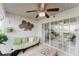 Inviting covered patio with comfortable seating, fan, and sliding glass doors to indoor space at 1109 Clubside Dr # 1109, Longwood, FL 32779