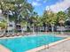 Community swimming pool with lounge chairs and tropical landscaping at 1109 Clubside Dr # 1109, Longwood, FL 32779