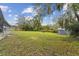 Large back yard featuring a storage shed with a kennel and views of mature trees at 1126 Turner Ln, Altamonte Springs, FL 32714