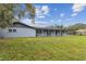 A large backyard with a covered patio and mature landscaping at 1126 Turner Ln, Altamonte Springs, FL 32714