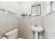 This charming bathroom is tiled and has a pedestal sink with a fancy gold mirror at 1126 Turner Ln, Altamonte Springs, FL 32714