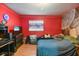 This red bedroom has a wall mural and wood-look floors at 1126 Turner Ln, Altamonte Springs, FL 32714