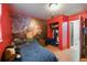 This bedroom has wood-look floors and a mural on the red wall at 1126 Turner Ln, Altamonte Springs, FL 32714