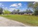 View of house featuring attractive stone accents, large front yard, and attached garage at 1126 Turner Ln, Altamonte Springs, FL 32714
