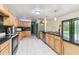 Spacious kitchen featuring granite countertops, wood cabinetry, stainless steel appliances, and tiled flooring at 1126 Turner Ln, Altamonte Springs, FL 32714
