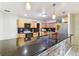Modern kitchen featuring granite countertops, wood cabinetry, stainless appliances, and tile flooring at 1126 Turner Ln, Altamonte Springs, FL 32714