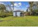 Backyard storage shed with a small, enclosed outdoor kennel at 1126 Turner Ln, Altamonte Springs, FL 32714