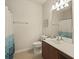 Neutral bathroom with a modern vanity, a large mirror and a shower with a curtain at 1205 Bella Rose Ct, Davenport, FL 33896