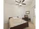 Cozy bedroom with carpet flooring, ceiling fan, a television and an ensuite bathroom at 1205 Bella Rose Ct, Davenport, FL 33896