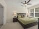 Spacious bedroom with a ceiling fan, plush carpet and a large window for natural light at 1205 Bella Rose Ct, Davenport, FL 33896