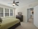 Bright bedroom featuring a ceiling fan, a window, an ensuite bathroom and a closet at 1205 Bella Rose Ct, Davenport, FL 33896