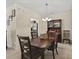 Elegant dining room with a dark wood table, chairs, and a stylish chandelier at 1205 Bella Rose Ct, Davenport, FL 33896