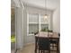 Bright dining area with a large window, neutral paint and a view of the backyard at 1205 Bella Rose Ct, Davenport, FL 33896