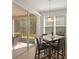 Dining room featuring a sliding glass door to the patio with tile flooring and a modern pendant light at 1205 Bella Rose Ct, Davenport, FL 33896