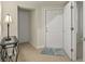 Bright foyer with tile flooring, white doors, and a decorative table with a lamp at 1205 Bella Rose Ct, Davenport, FL 33896