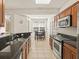 Well-lit kitchen with granite countertops, stainless steel appliances, and tile flooring at 1205 Bella Rose Ct, Davenport, FL 33896