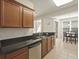 Well-lit kitchen with granite countertops, stainless steel appliances, and tile flooring at 1205 Bella Rose Ct, Davenport, FL 33896