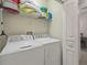 Laundry room features a washer, dryer, storage shelves and is located near the dining area at 1205 Bella Rose Ct, Davenport, FL 33896