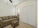 Cozy living room with carpet flooring, a comfortable sofa and a window with natural light at 1205 Bella Rose Ct, Davenport, FL 33896