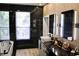 Modern bathroom featuring black marble walls, sleek fixtures, and ample natural light from a large window at 13413 Hopkinton Ct, Windermere, FL 34786