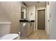 Modern bathroom features a unique mirror, wood grain vanity, and updated fixtures at 13413 Hopkinton Ct, Windermere, FL 34786