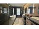 Modern bathroom with double vanity, soaking tub, and black marble accent wall at 13413 Hopkinton Ct, Windermere, FL 34786