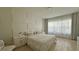 Cozy bedroom with a large window, stylish headboard and neutral color tones at 13413 Hopkinton Ct, Windermere, FL 34786