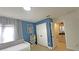 Bedroom features a light beige bed and blue walls, with a view into the bathroom at 13413 Hopkinton Ct, Windermere, FL 34786