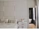 Serene bedroom with decorative headboard wall, ensuite bathroom with tub, and stylish decor at 13413 Hopkinton Ct, Windermere, FL 34786