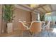 Contemporary dining area with modern wood accents and stylish chairs, illuminated by an elegant chandelier at 13413 Hopkinton Ct, Windermere, FL 34786
