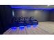 Home theater featuring tiered seating, custom lighting, and a modern design at 13413 Hopkinton Ct, Windermere, FL 34786