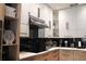 Contemporary kitchen with sleek cabinetry, black appliances, and a reflective backsplash, exuding modern elegance at 13413 Hopkinton Ct, Windermere, FL 34786