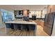 Modern kitchen featuring a large center island with seating, stylish countertops, and stainless steel appliances at 13413 Hopkinton Ct, Windermere, FL 34786