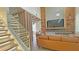 Open-concept living room with a modern staircase, cozy seating, and stylish decor at 13413 Hopkinton Ct, Windermere, FL 34786