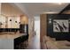 Inviting open-concept living room with kitchen, featuring modern black and white cabinets and a marble island at 13413 Hopkinton Ct, Windermere, FL 34786