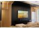 Modern living room with black accent wall, wood paneling, recessed lighting, and contemporary furniture at 13413 Hopkinton Ct, Windermere, FL 34786
