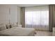 Bright main bedroom with a large window, modern decor, and light wood floors, creating a serene atmosphere at 13413 Hopkinton Ct, Windermere, FL 34786