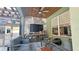 Outdoor living space featuring a seating area, television, and outdoor kitchen with modern finishes at 13413 Hopkinton Ct, Windermere, FL 34786