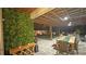 Beautiful outdoor patio with living wall, dining area, outdoor fireplace, and covered entertainment area at 13413 Hopkinton Ct, Windermere, FL 34786