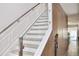 Elegant staircase with glass railings and wood treads, leading to the upper level at 13413 Hopkinton Ct, Windermere, FL 34786