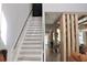 Bright staircase with white risers and light wood treads, leading to a modern living space at 13413 Hopkinton Ct, Windermere, FL 34786