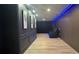 A sleek theater room with modern finishes and lighting at 13413 Hopkinton Ct, Windermere, FL 34786