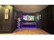 A home theater setup with wall art and games at 13413 Hopkinton Ct, Windermere, FL 34786