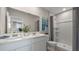 Bright bathroom featuring double vanity with modern fixtures and a shower with clear glass door at 1446 Ironbark Bnd, Davenport, FL 33837