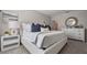 Well-lit bedroom featuring a decorative round mirror, a white dresser, and a cozy bed at 1446 Ironbark Bnd, Davenport, FL 33837