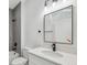 Modern bathroom featuring a white vanity with granite countertop and a framed mirror at 15163 Sw 29Th Terrace Rd, Ocala, FL 34473