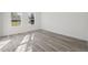 Spacious bedroom with light grey wood floors, white walls, and two windows that provide plenty of natural light at 15163 Sw 29Th Terrace Rd, Ocala, FL 34473